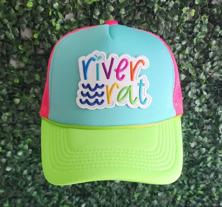 Are you ready to take your sipping experience to a whole new level of fun and fashion? Look no further than our River Rat Hat! This innovative and trendy beverage accessory is designed exclusively for girls who want to enjoy their favorite drinks with style and convenience. Our Lake Babe features a unique and eye-catching design that combines functionality and fashion. Crafted with the utmost care, this hat is made from high-quality materials that are both durable and lightweight, ensuring a comfortable fit for extended wear. The hat also includes a convenient and adjustable strap, ensuring a perfect fit for any head size. Whether you're hanging out with friends at a backyard barbecue, chilling by the pool, or attending a music festival, this hat will stay securely in place, allowing you t Fun Trucker Hat With Curved Bill For Outdoor, Playful Green Adjustable Trucker Hat, Playful Adjustable Green Trucker Hat, Playful Trucker Hat For Outdoor, Fun Green Trucker Baseball Cap, Fun Green Hats With Letter Print, Fun Green Baseball Cap For Outdoor, Summer Cute Green Trucker Hat, Trendy Multicolor Trucker Hat For Outdoor