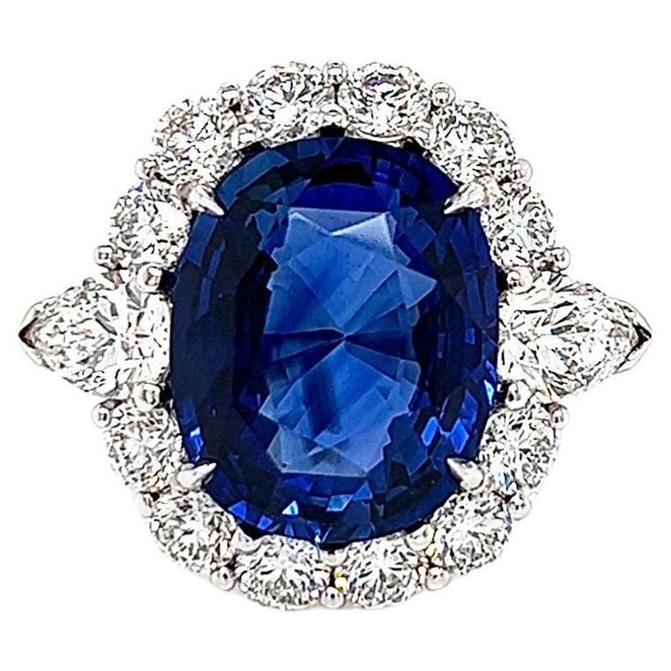 12.59Carat Sapphire and Diamond Halo Ladies Engagement Ring. GIA Certified -Metal Type: Platinum -Very Rare 10.01Carat Cushion Cut Natural Blue Sapphire, GIA Certified -Sapphire Color: Royal Blue -Sapphire Measurements: 13.73 x 11.12 x 7.09 mm -Geographic Origin: Madagascar -1.57Carat Round Natural side Diamonds. E-F Color, VS Clarity -0.51Carat Pear Cut Side Natural Diamond, GIA Certified (Report: 6117970271). F Color, VS2 Clarity -0.50Carat Pear Cut Side Natural Diamond, GIA Certified (Report: Madagascar 1, Pear Shapes, Favorite Engagement Rings, Flawless Diamond, Gem Mining, Sapphire And Diamond Ring, Sapphire Color, Ring Pictures, Engagement Ring Styles