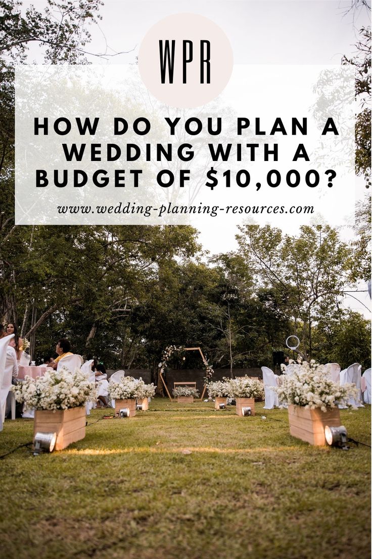 an outdoor ceremony with white flowers and candles on the grass