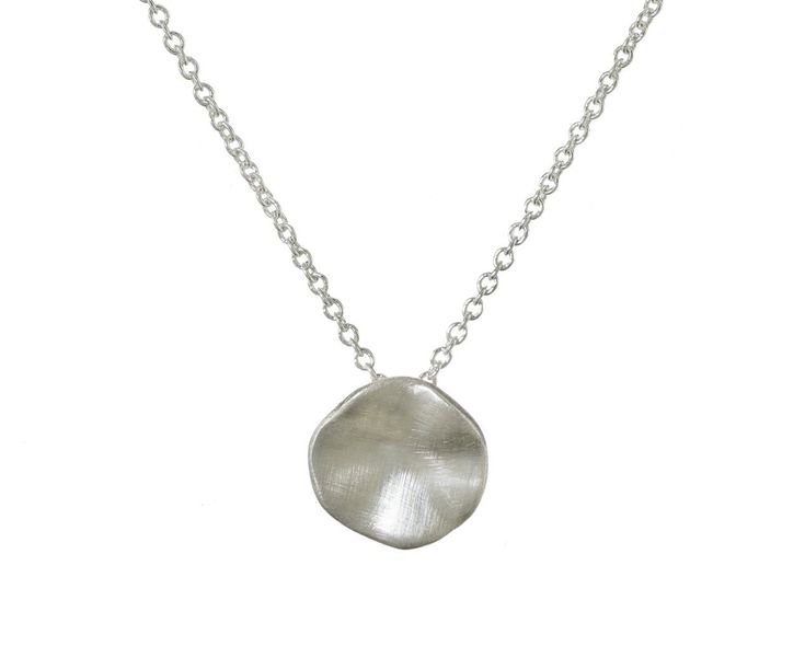 Earthy and understated, this Branch silver seed necklace is perfect for the jewelry lover who is just starting to build their collection. The slightly concave sterling silver pendant has a matte surface. It hangs from the base of a sterling silver chain. Wear this alone, or layer it with your other favorites for a personalized, eclectic look. total length : 16 1/2" : sterling silver sterling silver pendant : 3/8" diameter fastens with sterling silver spring ring clasp closure Delicate Sterling Silver Round Disc Jewelry, Sterling Silver Delicate Round Disc Jewelry, Sterling Silver Round Disc Delicate Jewelry, Silver Hammered Oval Pendant Necklace, Sterling Silver Coin Pendant Jewelry, Sterling Silver Necklace With Large Round Disc Pendant, Silver Flower Pendant Charm Necklace For Everyday, Delicate Sterling Silver Necklace With Polished Finish, Minimalist Nickel-free Necklace With Oval Pendant