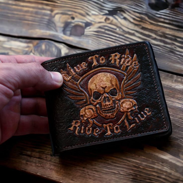 This wallet is made of high-quality leather, which provides it with durability and strength. But the main thing that makes this wallet unique is the skull embossing on its surface. This design element gives the wallet a special appeal and emphasizes your individuality. In addition, this wallet is very practical. The size of the purse is 10х11сm. The wallet has 1 section for banknotes and 6 credit card slots. Also, thanks to its compactness, this wallet easily fits in your pocket or bag. Don't mi Custom Wallets With Card Slots For Everyday Use, Custom Wallet With Card Slots For Everyday Use, Custom Wallet With Card Slots For Everyday Carry, Leather Biker Wallet For Biker Events, Skull Wallet, Biker Wallet, Custom Wallet, Leather Carving, Men's Wallet