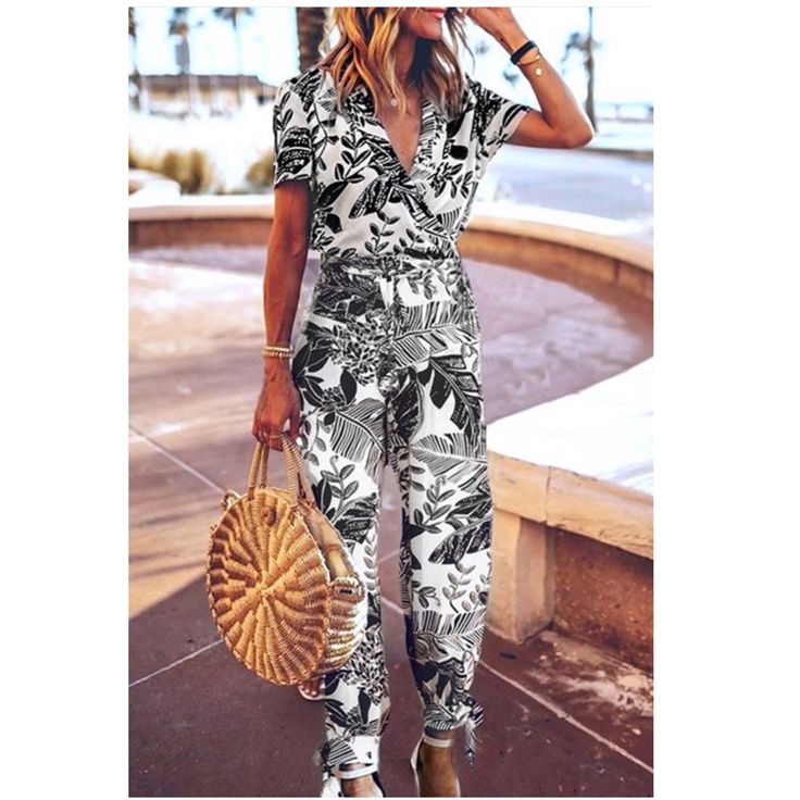 Stylish Lead Print Jumpsuit With Lapel Collar, Elastic Waistband, Ankle Bow Tie And Keyhole Back. Model Is Wearing A Small Made Of Rayon Small ( Bust) -34” Casual Short Sleeve Jumpsuits And Rompers For Vacation, White Casual Jumpsuits And Rompers For Beach, Casual White Jumpsuits And Rompers For The Beach, White Casual Beach Jumpsuits And Rompers, White Short Sleeve Jumpsuit For Vacation, Chic White Printed Jumpsuits And Rompers, Casual Printed Jumpsuit For Vacation, Printed Short Sleeve Jumpsuits And Rompers For Beach, Printed Short Sleeve Jumpsuits And Rompers For Vacation