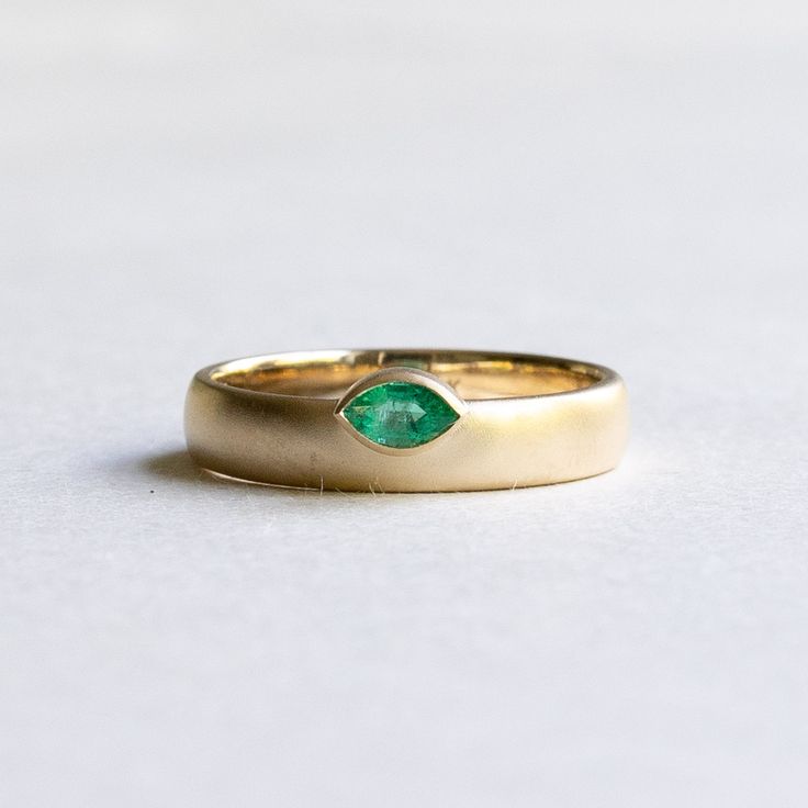 Off set emerald marquise band Metal: 14k yellow gold Stone: Natural emerald Stone Shape: Marquise Stone Size: 3x5 mm Finish: Matte Dimension: Approx 4mm band width Available in yellow, rose and white gold upon request Classic Marquise Emerald Ring, Gold Marquise Emerald Ring In 14k Gold, Marquise Emerald Ring In Yellow Gold, Classic Gold Marquise Emerald Ring, Marquise Emerald Ring For Promise In May, Classic Marquise Emerald Ring In Gold, Marquise Emerald Ring In Gold, Marquise Emerald Ring For May Birthstone, Emerald Marquise Promise Ring For May Birthstone