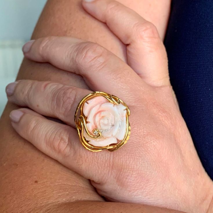 Crafted with exquisite attention to detail in Italy, this hand engraved ring in a stunning coral pink hue is a true work of art. The intricate design adds a touch of elegance and sophistication to any ensemble. Measuring 22mm in length and 20mm in width, this ring is a statement piece that will surely draw admiration. The vibrant color and meticulous craftsmanship make it a versatile accessory suitable for both formal occasions and everyday wear. Elevate your style with this unique ring that exu Elegant Coral Rings For Anniversary, Elegant Engraved Intaglio Ring For Gift, Heirloom Style Carved Engraved Ring For Gift, Heirloom Style Carved Engraved Ring As Gift, Heirloom Carved Engraved Ring Gift, Luxury Pink Flower Ring For Gift, Luxury Pink Flower Ring Gift, Fine Jewelry Pink Cabochon Ring, Elegant Coral Ring Jewelry