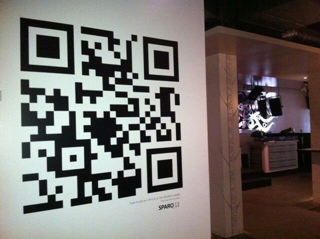 a wall with a qr code on it in a room filled with white walls