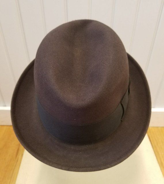 This iconic fedora hat is in excellent vintage condition: I can find no flaws other than on the cream silk satin lining which is soiled.  The lining is stamped:  Lock & Co. Hatters, St. James Street, London, Established 1759, Registered Trademark.As per Brooks Brothers:  "As the oldest hat shop in the world, Lock and Co. Hatters has provided headwear for men of distinction since 1676. From their home on St. James's Street in London, Lock and Co. serves a client base that includes His Royal Highn 1950s Mens Hats, Trilby Fedora, 1950s Mens, Mens Hats Fashion, Grey Fur, Men Hats, Cream Silk, St James, Fedora Hat