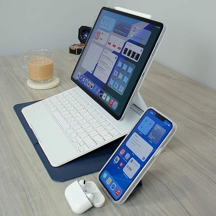 an open laptop computer sitting on top of a wooden table next to a mouse and keyboard