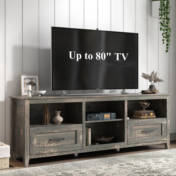 a tv stand with drawers and an up to 80 tv on it