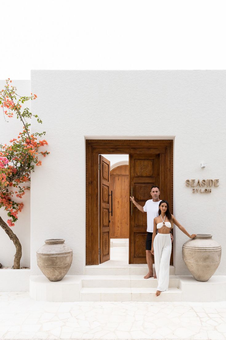 a man and woman standing in front of a door