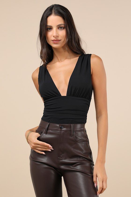 Going out has never looked so good thanks to the Lulus Truly Sultry Black V-Neck Ruched Sleeveless Bodysuit! Sleek and stretchy jersey knit shapes this must-have bodysuit with wide tank straps and a plunging V-neckline that creates a triangle-style bust. The figure-hugging bodice features strategic ruching at the sides for a flattering finish. Attached thong bottoms have snap closures. Fit: This garment fits true to size. Length: Size medium measures 28" from shoulder to hem. Bust: Great for any V-neck Bodysuit For Night Out With Lined Body, Spring V-neck Elastane Bodysuit, Chic V-neck Bodysuit For Going Out, Chic V-neck Top With Lined Body, Chic V-neck Bodysuit For Date Night, Chic Sleeveless Bodycon Top, Chic Low-cut Summer Tank Top, Elastane Tank Top For Night Out, Chic Ruched Tank Top