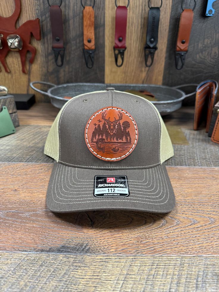 * Hand made in Liberty Ky * Deer Hunting Leather Patch Hat * I do offer custom patch's as well just message me  * You can check my Facebook page to see all my work.   https://www.facebook.com/profile.php?id=61551507831444&mibextid=LQQJ4d Custom Leather patch hats, Richardson 112 snap back. Hand Stitching for durability and longevity. I use top grade leather from Wicket & Craig English Bridle with Ritza Tiger Thread stitching. Each patch will be Top coated with resolene for a medium to high gloss finish, Water resistant acrylic top finish. There will be 5 colors of leather to choose from and a variety of stitching colors. I also offer/carry 13 colors of leatherette for a more vibrant look.  I do offer many more hat color options, if you don't see the color your looking for message me there' Western Style Adjustable Curved Brim Snapback Hat, Adjustable Brown Cap, Brown Adjustable Cap, Western Style Adjustable Baseball Cap With Curved Brim, Adjustable Western Snapback Hat With Curved Brim, Western Style Adjustable Snapback Hat With Curved Brim, Western Style Adjustable Snapback Hat With Flat Brim, Country Style Adjustable Snapback Hat, Casual Adjustable Hat Bands For Hunting