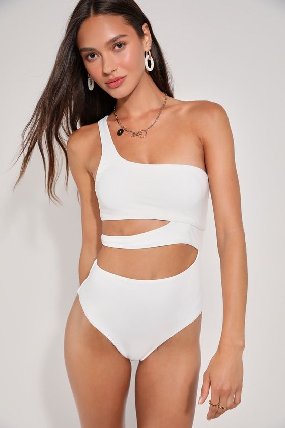 Get ready for sand, sun, and a whole lot of fun with the Lulus Sunshine Glow White Cutout One-Piece Swimsuit! This too-cute swimsuit is composed of sleek and stretchy tricot knit that shapes a flirty one-shoulder neckline and a bandeau-style bodice with an asymmetrical strap that creates cute cutout effects at the side, all above a pair of attached bottoms with high-cut legs and cheeky bottom coverage. Removable padding. PLEASE NOTE: Swimwear returned without the hygienic liner is non-refundable Cutout One-piece Bodysuit For Beachwear, Cutout Swimwear For Beach Party Season, Summer Cutout Stretch Swimwear, Beach Party Swimwear With Cutout, Summer Stretch Cutout Swimwear, Stretch Cutout Swimwear For Summer, Stretch Beachwear Bodysuit With Cutout, One-piece Cutout Bodysuit For Swimming, Cutout Swimwear For Beach Party In Summer