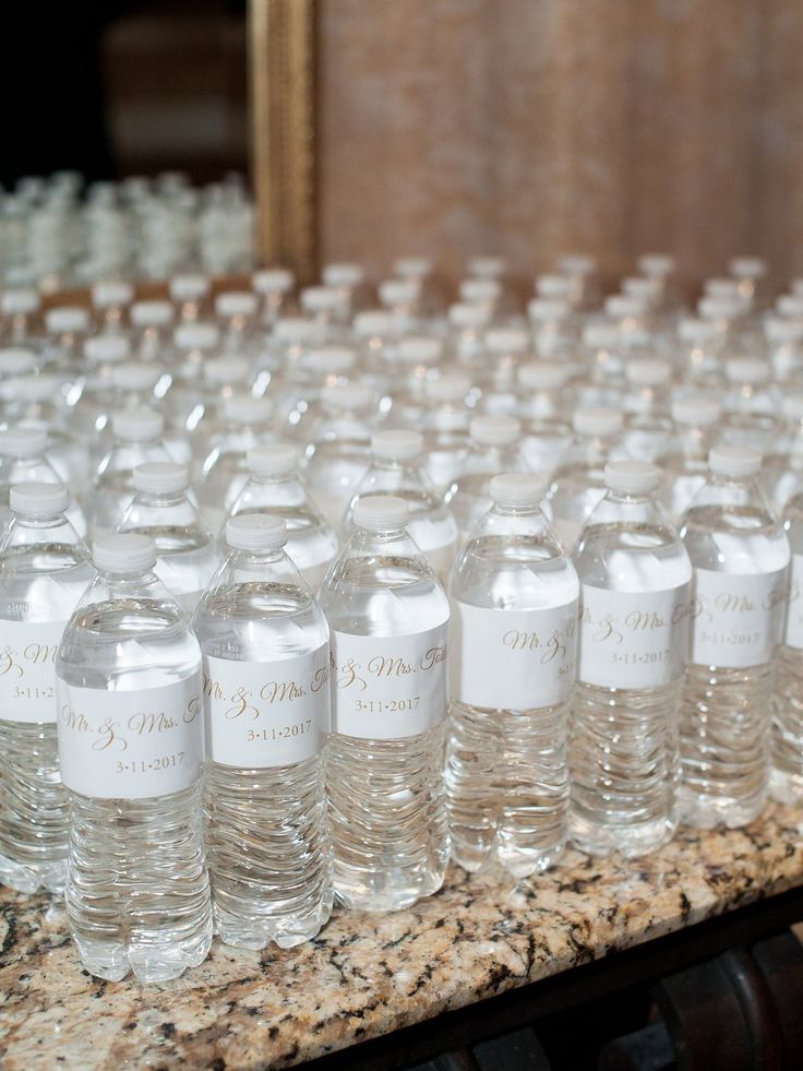 rows of bottled water bottles lined up on a counter