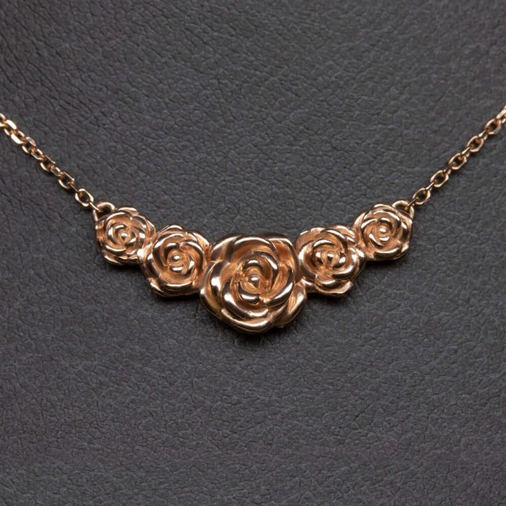 This beautiful and unique botanical necklace features a cluster of blossoming roses intricately rendered in 14k rose gold. Inspired by the boundless and surprising beauty of the natural world, this necklace offers a dreamy air of fairytale romance! The necklace is pictured in solid 14k rose gold and can be made in yellow or white gold as well. The pendant measures 21.6 x 8.8mm. The chain is 18 inches in length.This unique botanical necklace is an Ivy and Rose original design, so you will not fin Pendent Designs, Rose Necklace Gold, Botanical Necklace, Fairytale Romance, Fantasy Things, Rose Blossom, Shiny Rings, Necklace Ideas, Necklace Flower