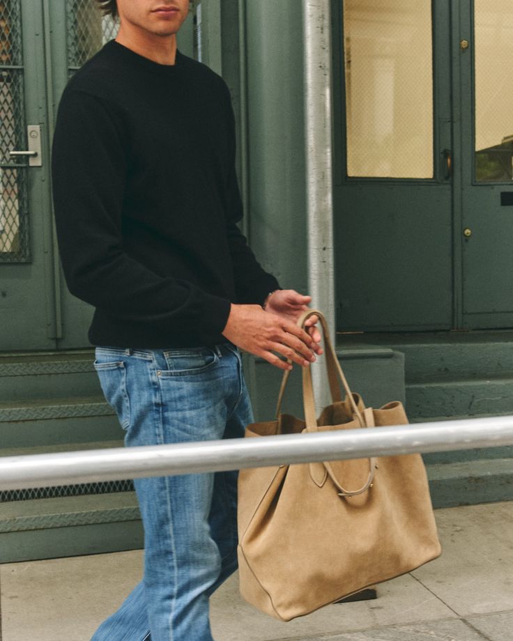 The E42 is the ideal bag for the man on the go. Taking you easily from the office, to the gym, to a weekend away, the E42 makes a perfect travel companion. The style is kept unlined for a more casual and lightweight feel, and hardware is minimal to retain a sleek, easygoing feel. Available in warm Acorn, fresh Ivory, or classic Black tumbled-grain leather. Everyday Leather Travel Bag, Casual Leather Satchel, Casual Leather Satchel For On-the-go, Casual Everyday Satchel Weekender Bag, Casual Leather Duffle Bag For On-the-go, Casual Leather Travel Bag With Top Carry Handle, Casual Duffle Bag With Leather Handles For On-the-go, Casual Weekender Bag For Everyday Use, Modern Weekender Bag For Daily Use