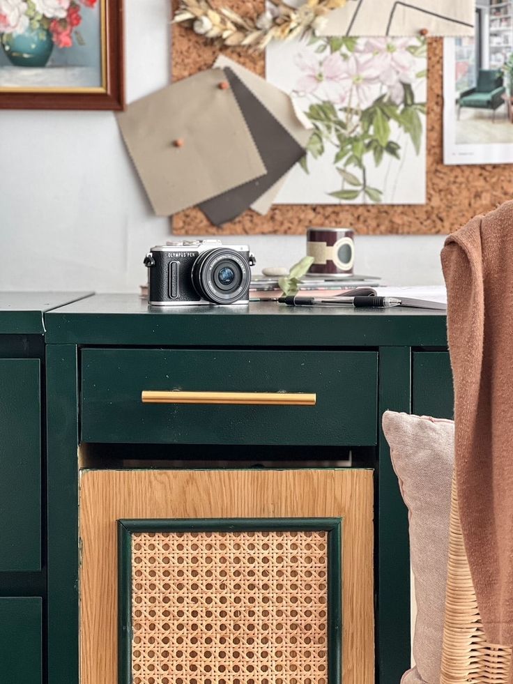 a table with a camera and some pictures on the wall