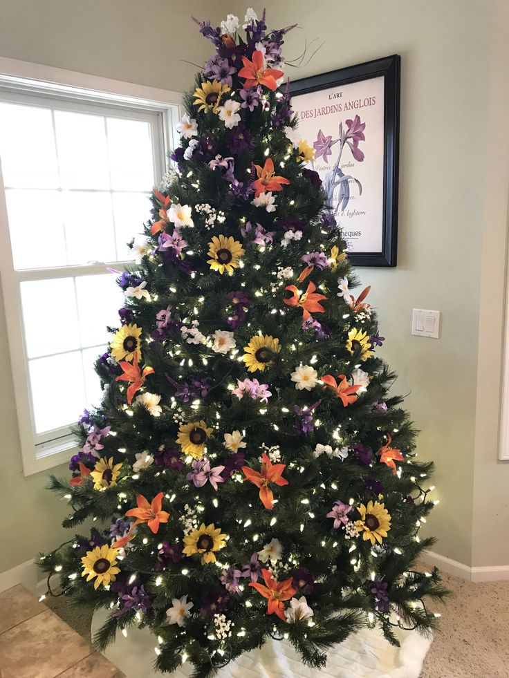 a decorated christmas tree in the corner of a room