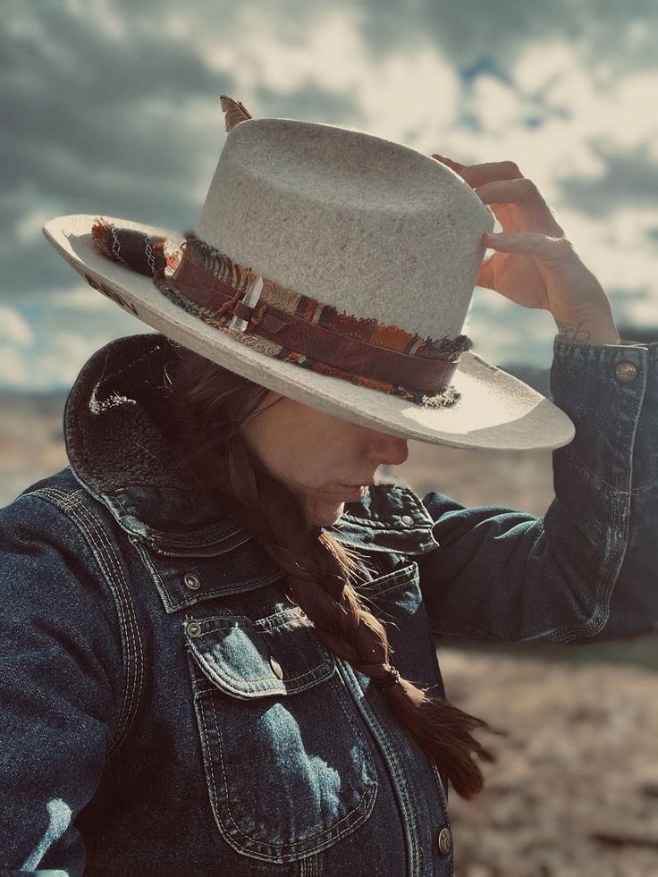 - The Desert Bird  *  Cream wool * Leather band with quartz crystal   & Thunderbird conch   Upcycled hat liner  * California turkey feather * Size 8 Artisan Short Brim Felt Hat For Fall, Artisan Felt Hat With Short Brim For Fall, Artisan Winter Fedora For Rodeo, Artisan Flat Brim Hat For Fall, Winter Feathered Flat Brim Felt Hat, Artisan Hats For Ranch In Fall, Artisan Flat Brim Felt Hat For Fall, Winter Felt Hat With Feathers And Flat Brim, Bohemian Wool Hat With Flat Brim