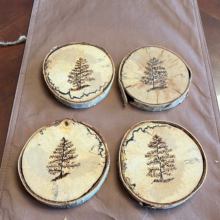 four pieces of wood with trees on them