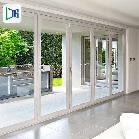 an open kitchen and living room with sliding glass doors