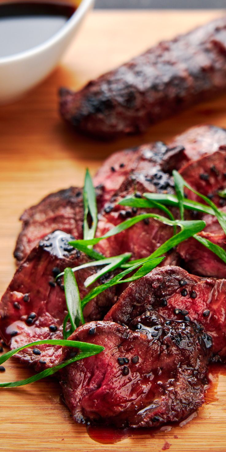 some meat is sitting on a cutting board