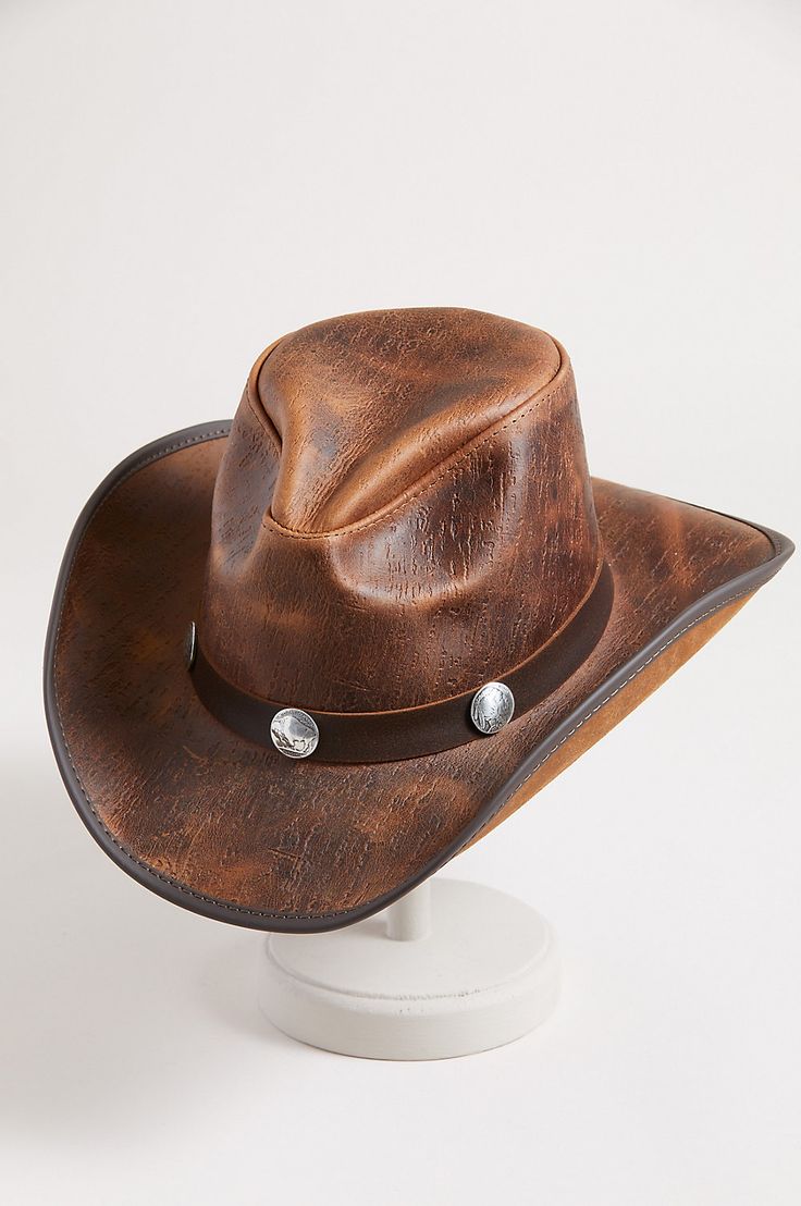 Honor your inner cowboy or cowgirl with the Renegade leather hat. From the handcrafted pinch crown to the 3" vinyl edged shapeable brim, this cowhide leather hat crowns you with good looking western flair. A matching hatband with buffalo conchos adds the perfect finish to a year round hat you can shape to your liking for just the right look, while the adjustable sweatband gives you a custom fit. Rustic Leather Fedora For Rodeo, Leather Fedora Hats For Rodeo, Leather Brimmed Fedora For Rodeo, Western Leather Fedora With Flat Brim, Brown Leather Fedora For Rodeo, Western Style Leather Fedora With Flat Brim, Rustic Leather Fedora For Western-themed Events, Leather Fedora For Rodeo With Short Brim, Rugged Leather Hats For Western-themed Events