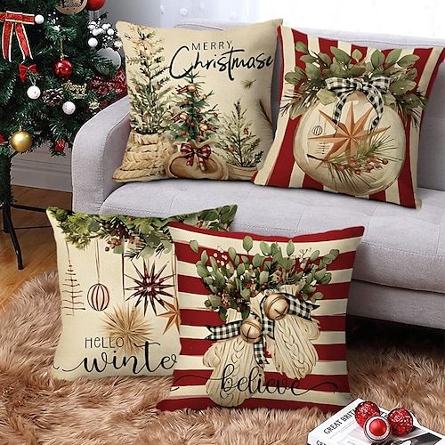 three christmas pillows sitting on top of a couch next to a christmas tree and other decorations