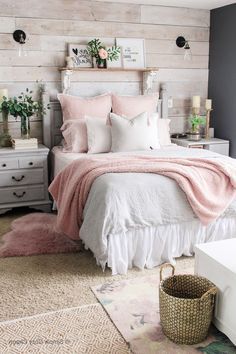 a bedroom with a bed, dressers and baskets on the floor in front of it