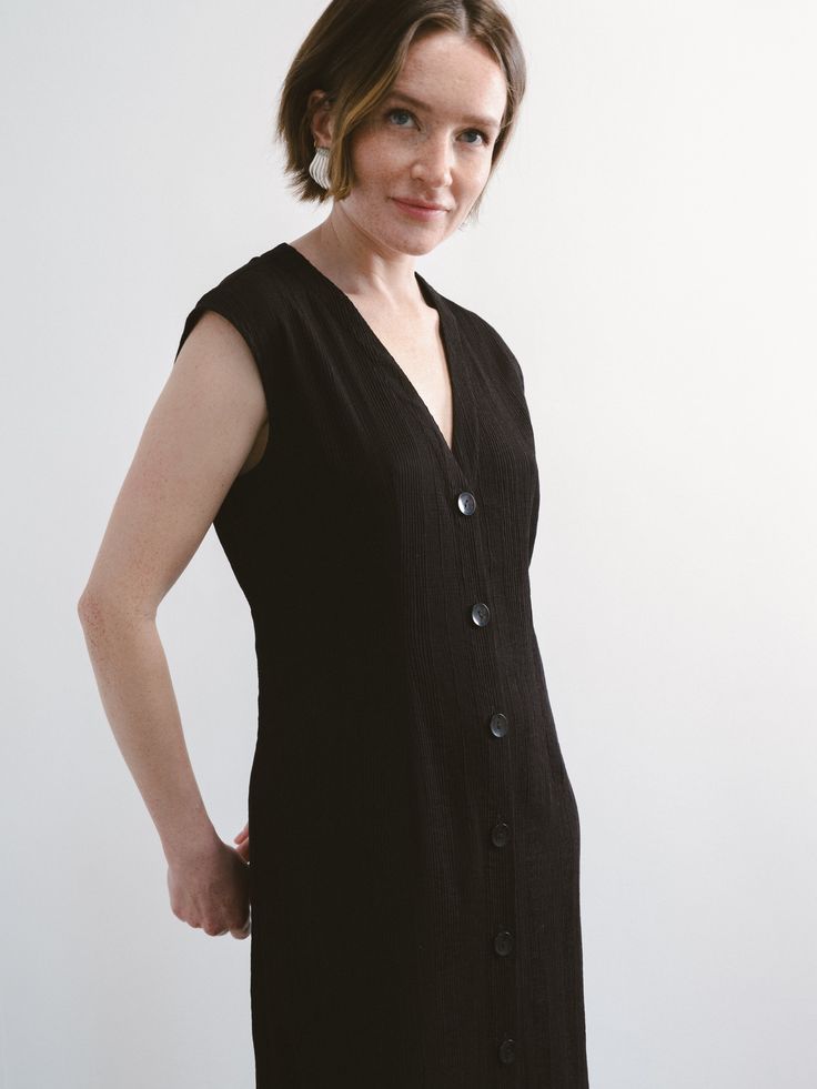 This little black dress has that beautiful, classic French feeling; the silhouette is easy and flattering with unique fabric texture, elegant front buttons and a tie to adjust the shape at the back. Wear this as a one-and-done look and let your shoes change the look each time, reminding you that each day is a gift!