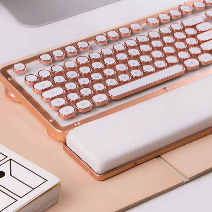 a computer keyboard sitting on top of a desk next to a mouse and pen holder