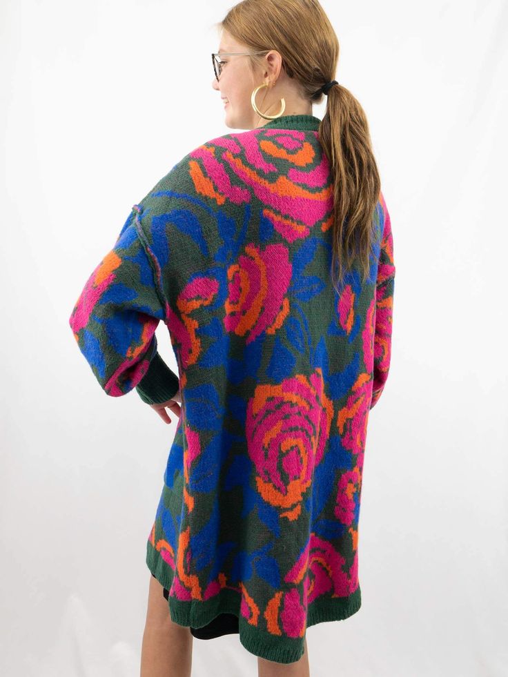 This Oversized Floral Cardigan is in a delightful palette of hunter green, pink, blue, and orange hues. It features a charming floral pattern and comes in an oversized fit for a cozy and stylish look. With the added convenience of pockets, it's the perfect combination of fashion and functionality. Pair it with leggings or a t-shirt dress. SIZE & FIT Oversized fit Model is 5'6" wearing size small Bohemian Floral Print Winter Cardigan, Vintage Floral Print Cardigan For Fall, Fall Vintage Floral Print Cardigan, Bohemian Floral Print Sweater For Fall, Multicolor Floral Print Long Sleeve Cardigan, Casual Multicolor Floral Print Cardigan, Casual Oversized Floral Print Cardigan, Oversized Casual Cardigan With Floral Print, Casual Colorful Oversized Outerwear