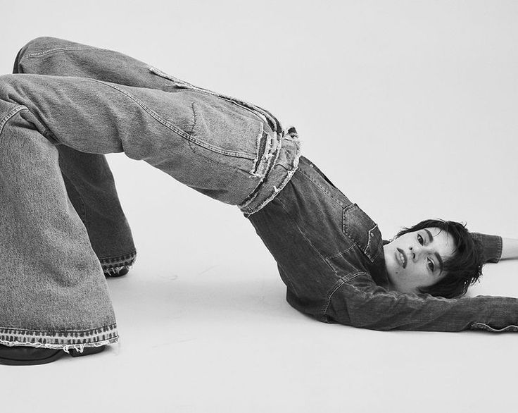 a young man laying on the ground with his legs spread out in front of him