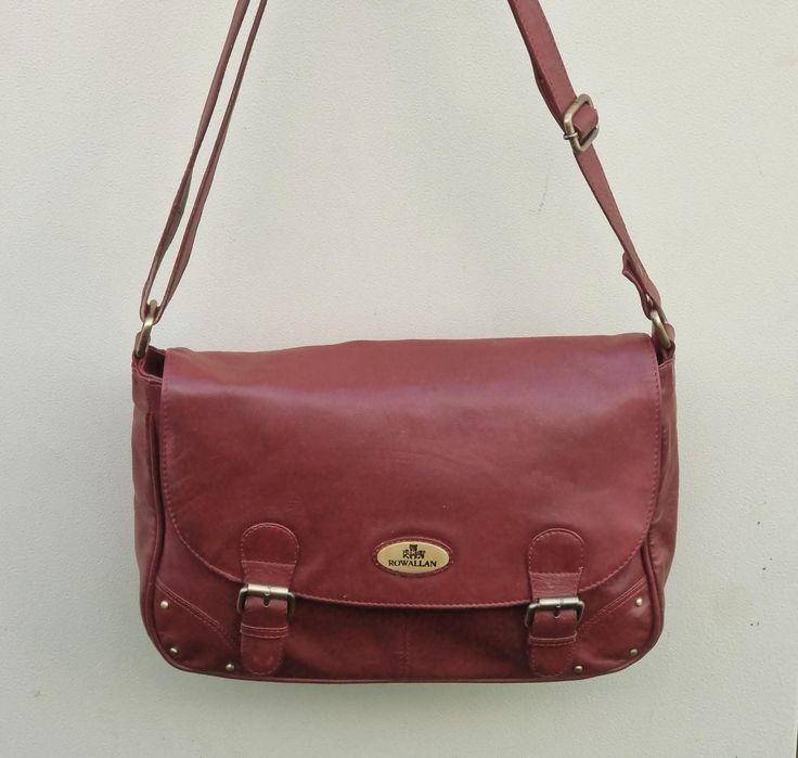 Vintage Rowallan dark red / burgundy leather satchel messenger bag, long cross body shoulder strap;  Classic satchel styling with buckle detailing to the front with magnetic snap for ease of closure.  Long adjustable length cross body shoulder strap.  Inside lined in red material which does have a little catching near the zip pocket (shown in the photo)  there are also two leather trimmed pouch pockets, lining is clean.  The overall condition of the bag is very good, no major scuffing or damage. Burgundy Rectangular Satchel With Adjustable Strap, Burgundy Crossbody Flap Bag With Adjustable Strap, Classic Burgundy Shoulder Bag With Adjustable Strap, Burgundy Flap Bag With Detachable Strap For Everyday Use, Vintage Burgundy Bag With Adjustable Strap, Burgundy Crossbody Satchel With Adjustable Strap, Burgundy Satchel For Daily Use, Vintage Burgundy Shoulder Bag With Adjustable Strap, Vintage Burgundy Shoulder Bag For Everyday