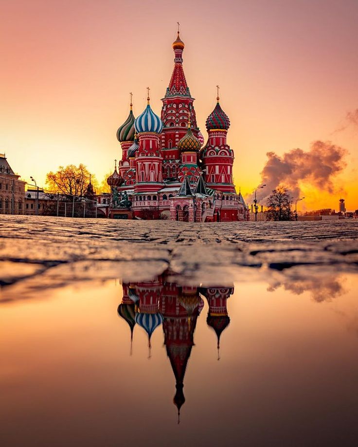 an image of a church that is reflecting in the water at sunset or sunrise time