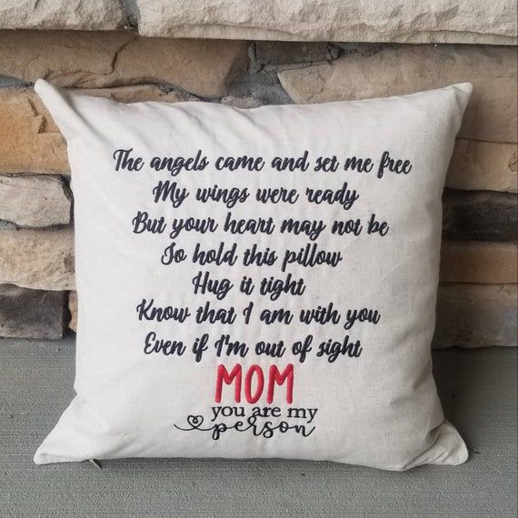 a white pillow with the words mom on it