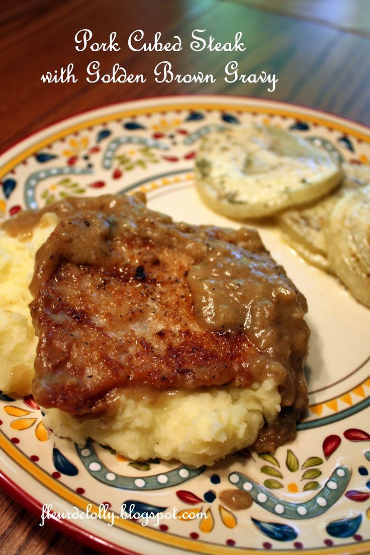 steak and mashed potatoes on a plate with gravy