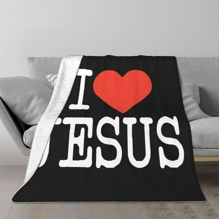 a couch with a black and white blanket that says i love jesus on the front