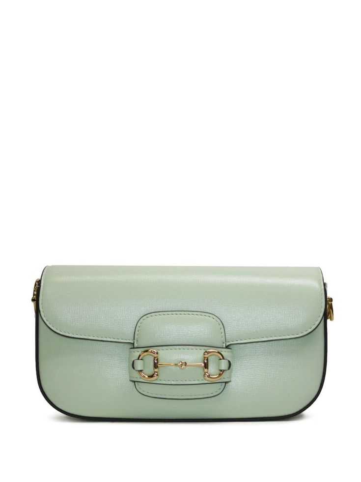 Horsebit 1955 small shoulder bag from Gucci featuring mint green, leather, signature Horsebit detail, gold-tone hardware, foldover top with magnetic fastening, single top handle, main compartment and internal zip-fastening pocket. Chic Gucci Satchel With Removable Pouch, Gucci Crossbody Satchel With Gold-tone Hardware, Green Gucci Bag With Detachable Handle, Gucci Satchel With Branded Hardware For Evening, Gucci Satchel With Removable Pouch For Formal Occasions, Gucci Evening Satchel With Branded Hardware, Gucci Formal Satchel With Removable Pouch, Chic Gucci Crossbody Satchel, Gucci Shoulder Satchel With Gold-tone Hardware