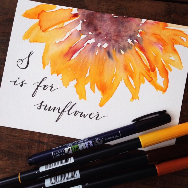 three pens are sitting next to some watercolors and a card that says, it's for sunflower