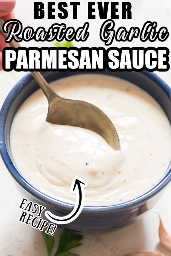 the best ever roasted garlic parmesan sauce in a blue bowl with a spoon