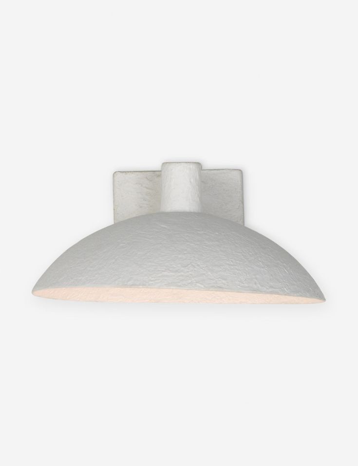 a white light fixture on a wall