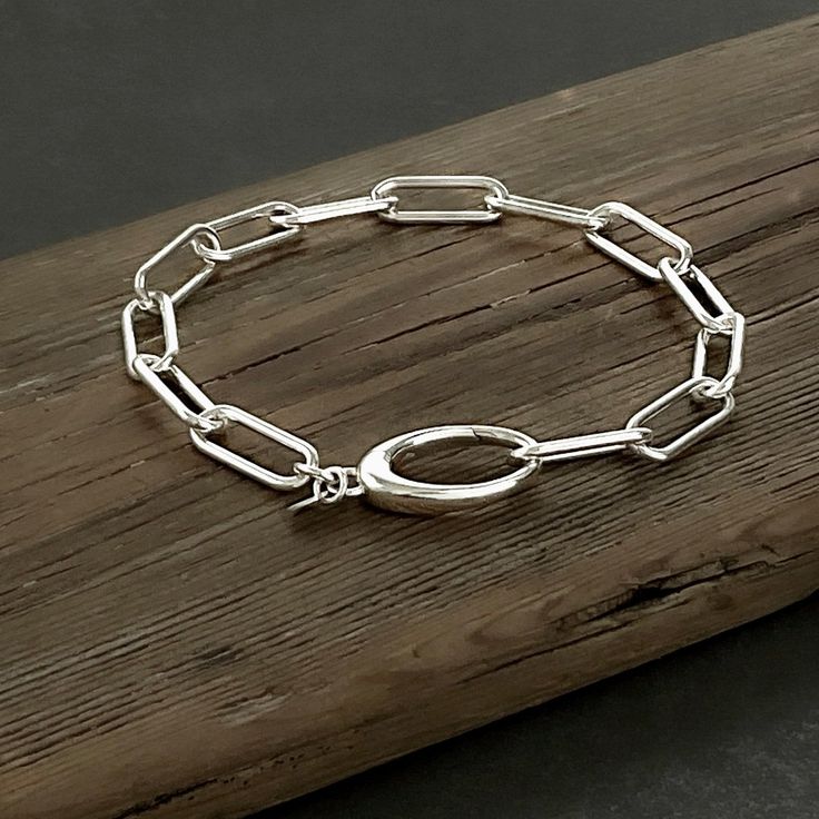 Chunky paperclip chain bracelet in sterling silver featuring a large, easy-to-use, sleek oval clasp. A minimalist yet bold statement piece. Details: Chain: Sterling Silver Paperclip Chain, 6mm Clasp: Sterling Silver Oval hinged push clasp, 22mm Lengths: 6” to 10” Shipping: Ready to ship within one business day Complimentary shipping in the USA Complimentary gift wrap Everyday Sterling Silver Bracelet With Chunky Chain, Sterling Silver Classic Bracelet With Paperclip Chain, Classic Sterling Silver Bracelet With Oval Link Paperclip Chain, Minimalist Sterling Silver Oval Link Bracelet, Everyday Sterling Silver Chunky Chain Bracelet, Modern Sterling Silver Bracelet With Chunky Chain, Modern Sterling Silver Paperclip Chain Bracelet, Elegant Silver Paperclip Bracelet With Chunky Chain, Elegant Sterling Silver Bracelet With Oval Link Paperclip Chain