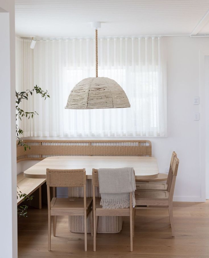 a dining room table with chairs and an umbrella hanging over it