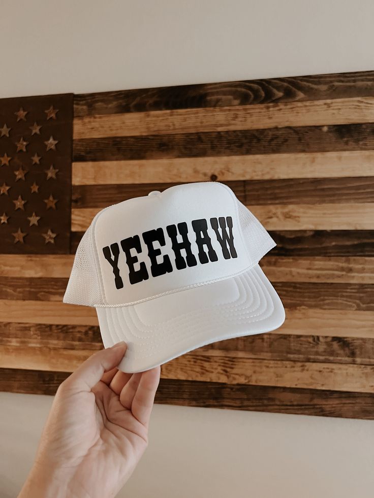 "White high crown snapback trucker hat detailed with black western \"YEEHAW\" graphic. Perfect for summer days by the pool, river, lake, and country festivals/concerts!"