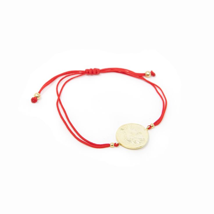 A two-sided reversible gold coin medallion on either a red cord bracelet or black cord bracelet. We love these worn together! Side one features a hero cameo and side two features a bull design. We love the old world charm of these medallion style adjustable bracelets with a classic cord design. Details: Material: High quality gold plated brass with a cord bracelet Length: Fully extended 8 ½” Size: Adjusts to fit most Coin: 3/4" in diameter Adjustable Medallion Jewelry With Charms, Gold Jewelry With Adjustable Cord For Good Luck, Bull Design, A Bull, Roman Coins, Cord Bracelet, Gold Coin, A Hero, Cord Bracelets