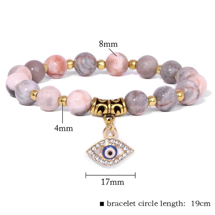 Step into a world of protection and style with our 8MM Beaded Trendy Evil Eye Charm Bracelet. Adorned with natural stone beads and the symbolic Evil Eye charm, this bracelet is a fashionable and meaningful accessory that wards off negativity. Key Features: Evil Eye Charm: A symbol of protection, the Evil Eye charm shields against negative energy and brings good fortune. 24 Crystal Variants: Choose from a wide array of crystal variants, each with its unique energy, allowing you to personalize you Eye Charm Bracelet, Stone Energy, Zebra Jasper, Jasper Bracelet, Energy Bracelets, Handmade Fashion Jewelry, Natural Stone Jewelry, Pink Zebra, Evil Eye Charm