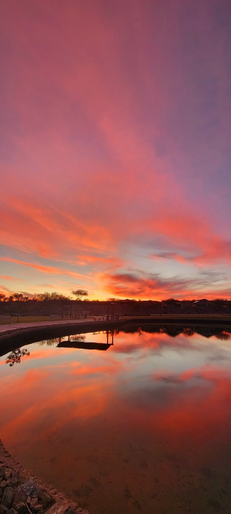 the sun is setting over a body of water