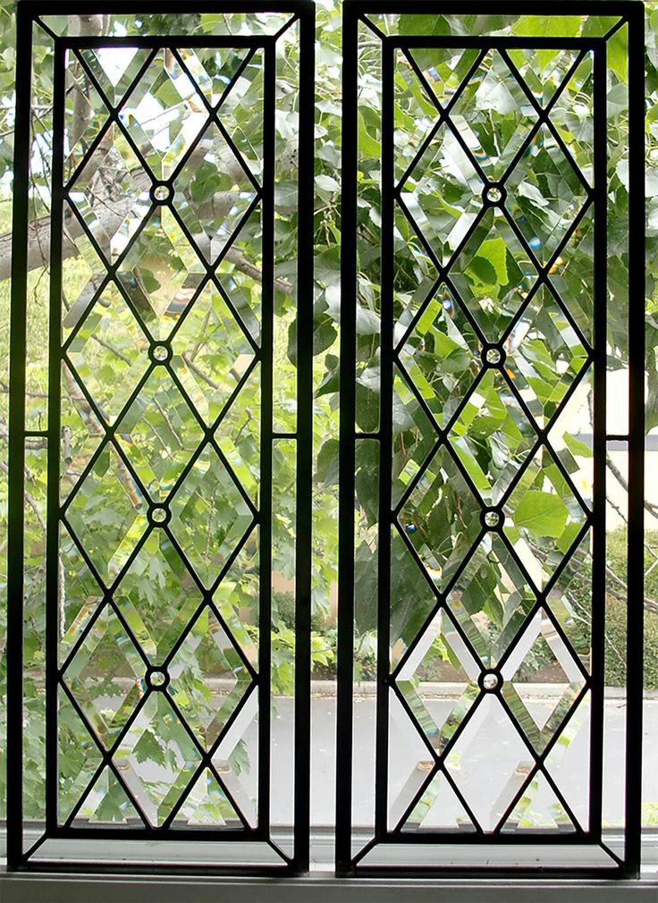 an open window with green leaves in the background