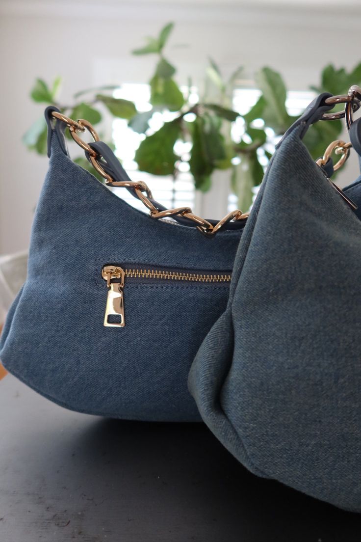 Created from durable denim, this handbag combines functionality with trendy aesthetic! With its versatile style, you’ll be adding this bag to every outfit this summer. Zipper closure Outside pocket 2 inside pockets Detachable strap Measurements: Width: 13” Height: 7.5” Denim Blue Bags For Everyday Use, Denim Blue Bags With Zipper Closure For Everyday Use, Everyday Denim Blue Bag With Zipper Closure, Everyday Denim Blue Bag With Zipper, Trendy Denim Blue Bag With Zipper Pocket, Denim Shoulder Bag With Zipper For Daily Use, Everyday Denim Shoulder Bag With Zipper, Daily Use Denim Shoulder Bag With Zipper, Daily Use Denim Shoulder Bag With Zipper Closure