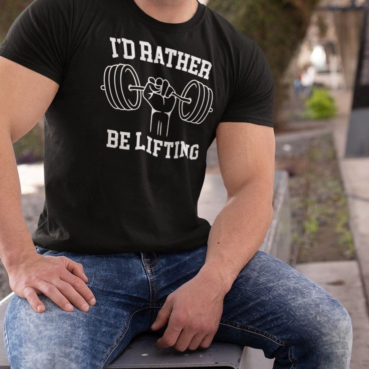 Are you looking for the perfect gift for the fitness enthusiast in your life? Look no further than the "I’d Rather Be Lifting" T-shirt from Kooskadoo! This stylish tee is perfect for any man who loves to hit the gym and lift weights. Whether they are into bodybuilding, powerlifting, or weightlifting, this T-shirt is sure to motivate them to reach their fitness goals.The I’d Rather Be Lifting T-shirt is made from high-quality activewear fabric, so it's comfortable and breathable. It's perfect for Sporty Text Print T-shirt For Gym, Relaxed Fit Gym T-shirt With Text Print, Athleisure Slogan T-shirt For Workout, Sporty Workout T-shirt With Slogan, Black Workout T-shirt With Slogan, Workout T-shirt With Text Print, Workout Short Sleeve T-shirt With Text Print, Text Print Workout T-shirt, Tri-blend Cotton T-shirt For Gym